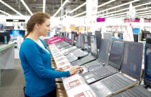 woman buying a laptop in store.
